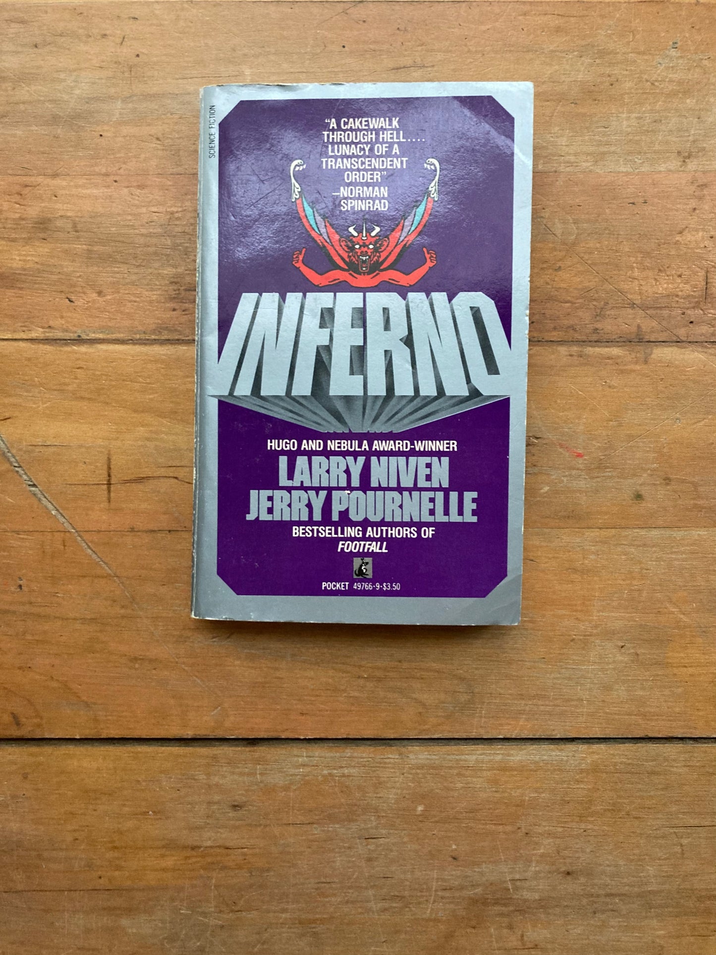 Inferno by Larry Niven & Jerry Pournelle. Pocket Books.